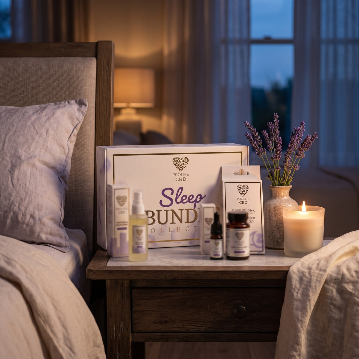 ProLife CBD Sleep Bundle on a bedside table: CBD sleep oil, sleep capsules, pillow spray and sleep patches with the gift box